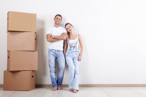Professional office movers packing desks and equipment for relocation