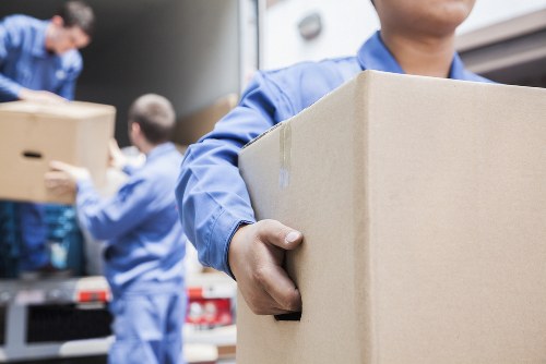 Man with van movers loading boxes into a transport van