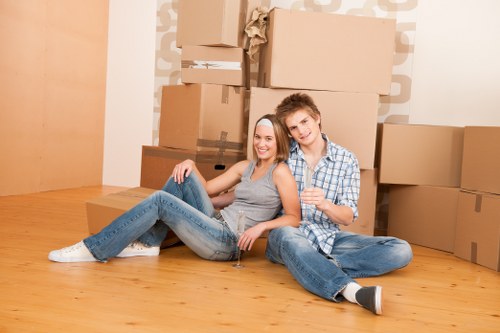 Professional movers packing household items carefully into labeled boxes