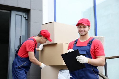 Movers loading items safely with protective moving equipment