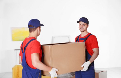 Professional office movers packing business equipment for relocation