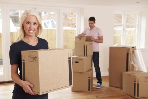 Team using gloves and safety gear while moving furniture