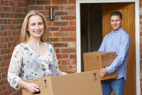 Movers preparing IT equipment and office technology for transport