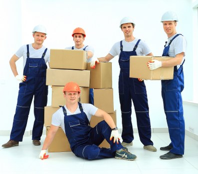 Professional movers preparing boxes and furniture for a removal service