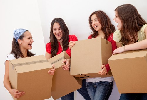 Mover loading household items into a van for a UK relocation service