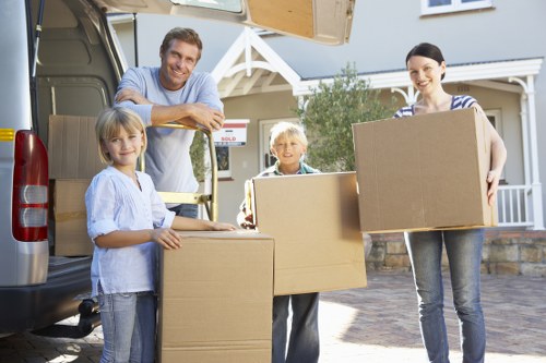 Furniture removal specialists navigating a staircase with large items