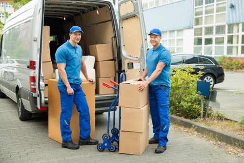 House removalists organising packed boxes before relocation
