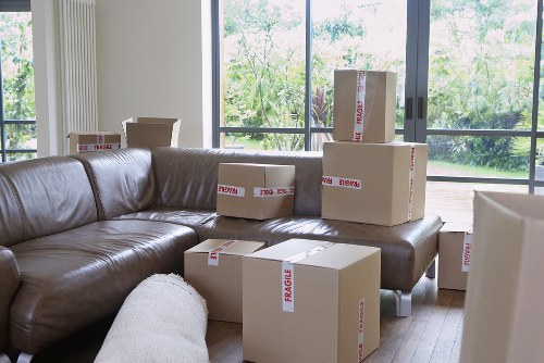 Urgent moving team loading furniture into a removal van