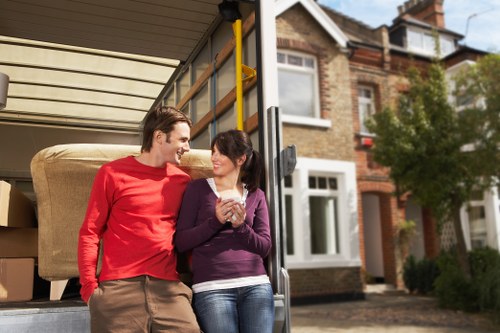 Two movers placing a dresser into a truck during a furniture pickup